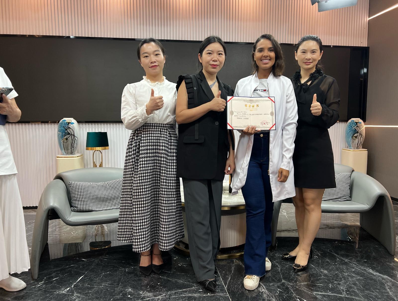 Dr. Paloma with the Chinese pioneers who trained her, holding the certification